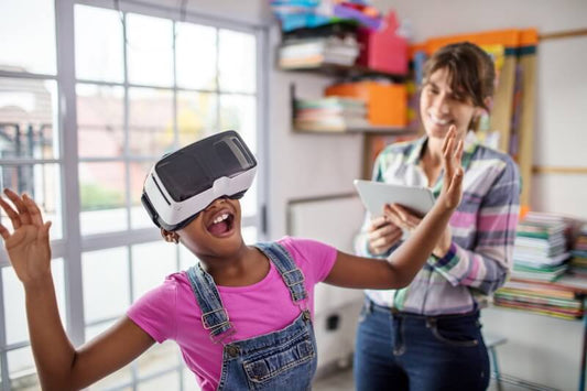 Student in Classroom Smiling Wearing Virtual Reality Goggles and Raising one arm in the the air